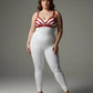 Plus-size red bra-style faux leather harness set worn by a model in a white bodysuit
