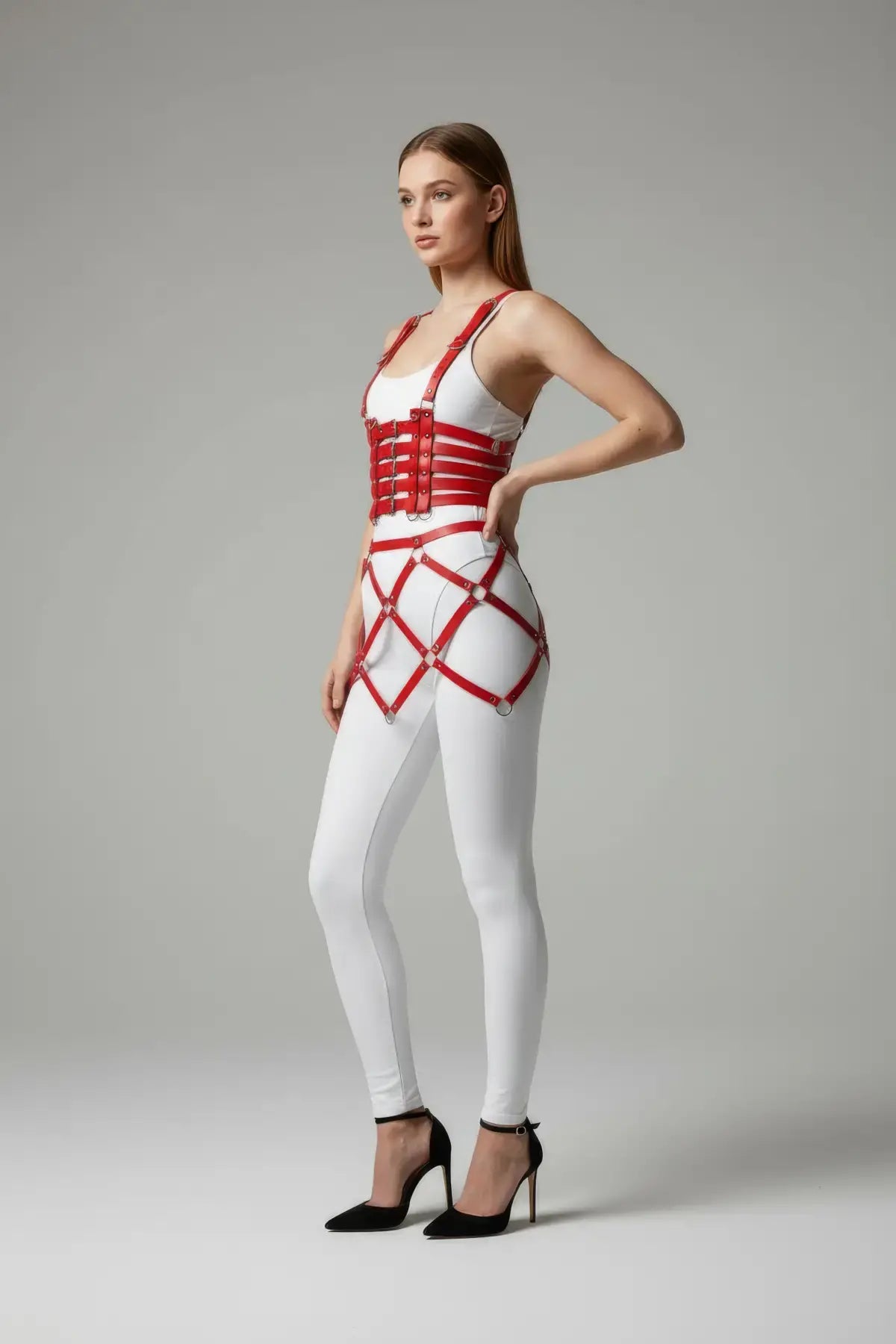 Plus-size red buckled suspender corset body harness with diamond cage skirt over white leggings