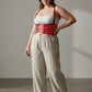 Plus-size red cage suspender corset harness in vegan leather worn over a white tank top by HarnessClub