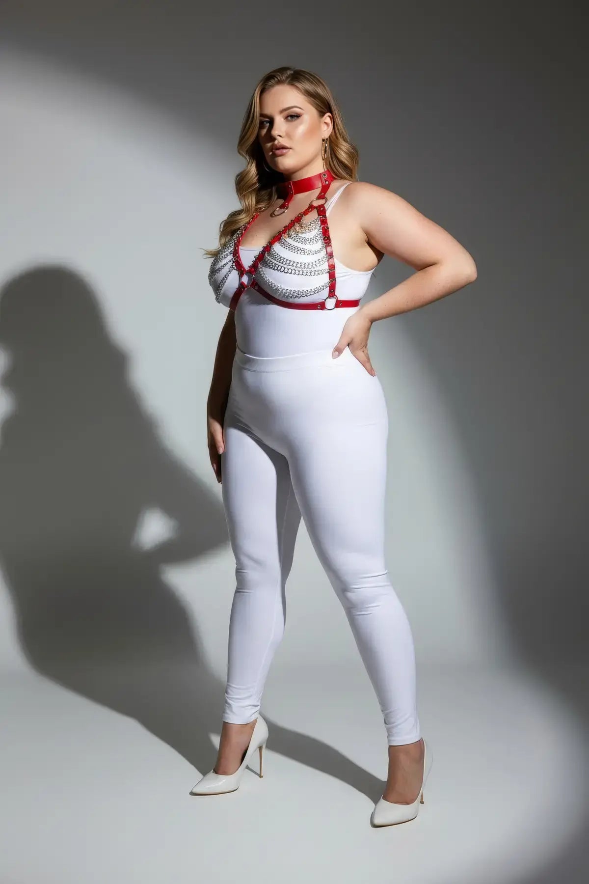 Plus-size red faux-leather harness with choker collar and connected metal chains on model