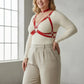 Plus-size red chain cage chest harness in vegan leather worn over a cream top.