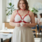 Plus-size red vegan leather chain cage chest harness worn over a white top