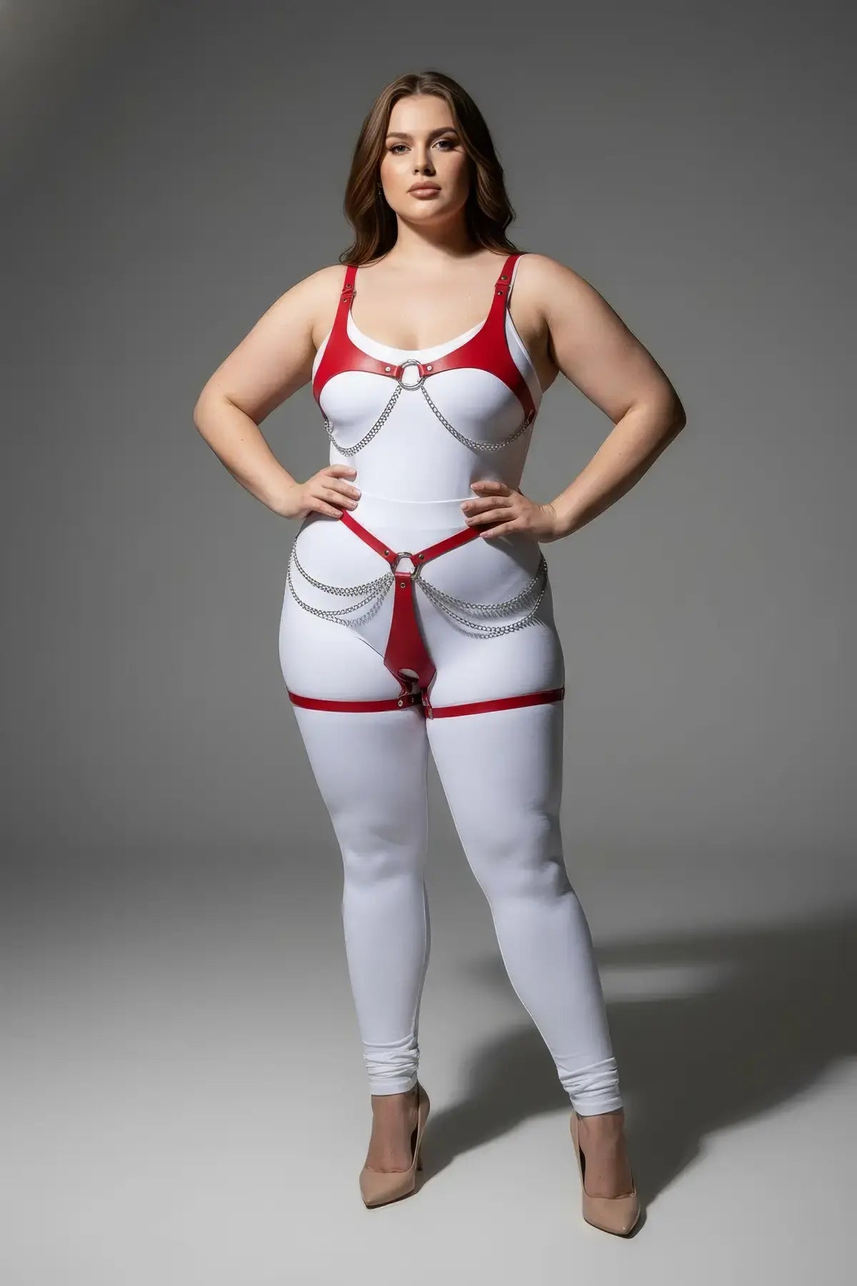 Plus-size red chain-detail faux leather body harness set on white bodysuit with silver chains; HarnessClub