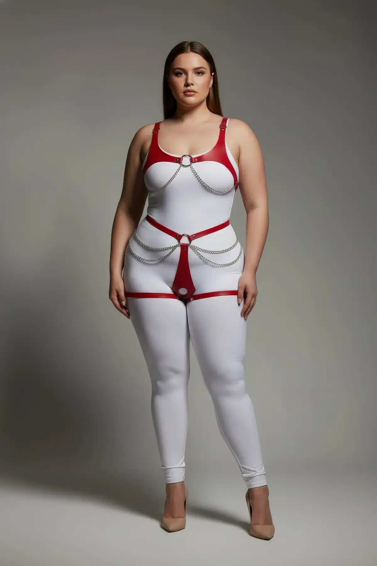 Plus-size red chain-detail faux leather body harness set on white bodysuit with silver chain accents