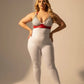 Plus-size HarnessClub red chain-detail faux leather harness set featuring a silver chain-bralette and red waist belt on a model.