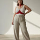 Plus size red chain-detail leather body harness worn over a white tank top