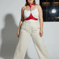 Plus-size red leather body harness with chain detail by HarnessClub worn by model