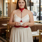 Plus-size red chain-detail leather body harness worn around neck and waist.