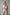 Plus Size Red Leather Harness with Chain Detail by HarnessClub worn diagonally across the torso over a white tank top