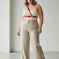 Plus-Size red chain-detail leather harness by HarnessClub worn across the torso over a white top.