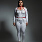 Plus-size red chain-swag collar and waist harness set in vegan leather worn over a white bodysuit; HarnessClub.