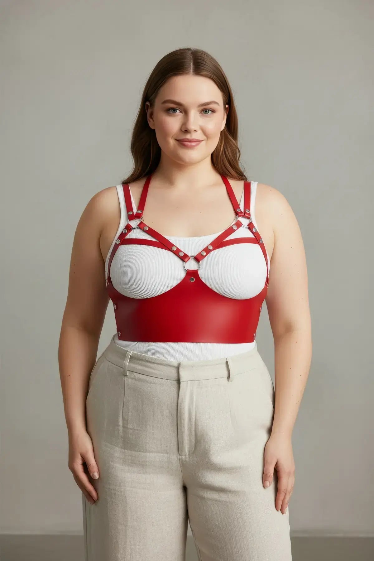 Plus Size Red Chic Leather Body Accessory by HarnessClub on model; red strappy leather harness with metal hardware.