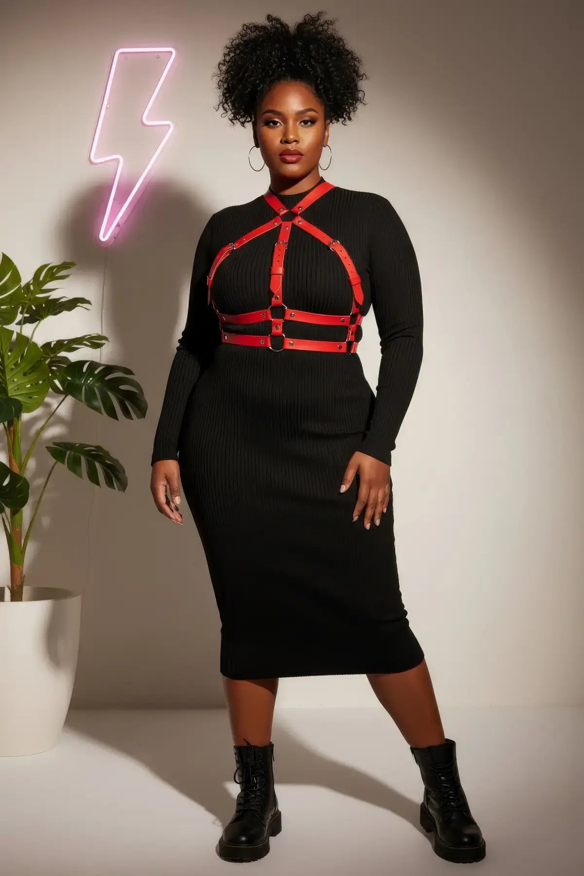 Plus-size red choker-collar vegan leather full-body harness worn over a black dress