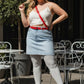 Plus Size Red Classic Buckle Leather Belt worn over white crop top and light denim skirt outdoors