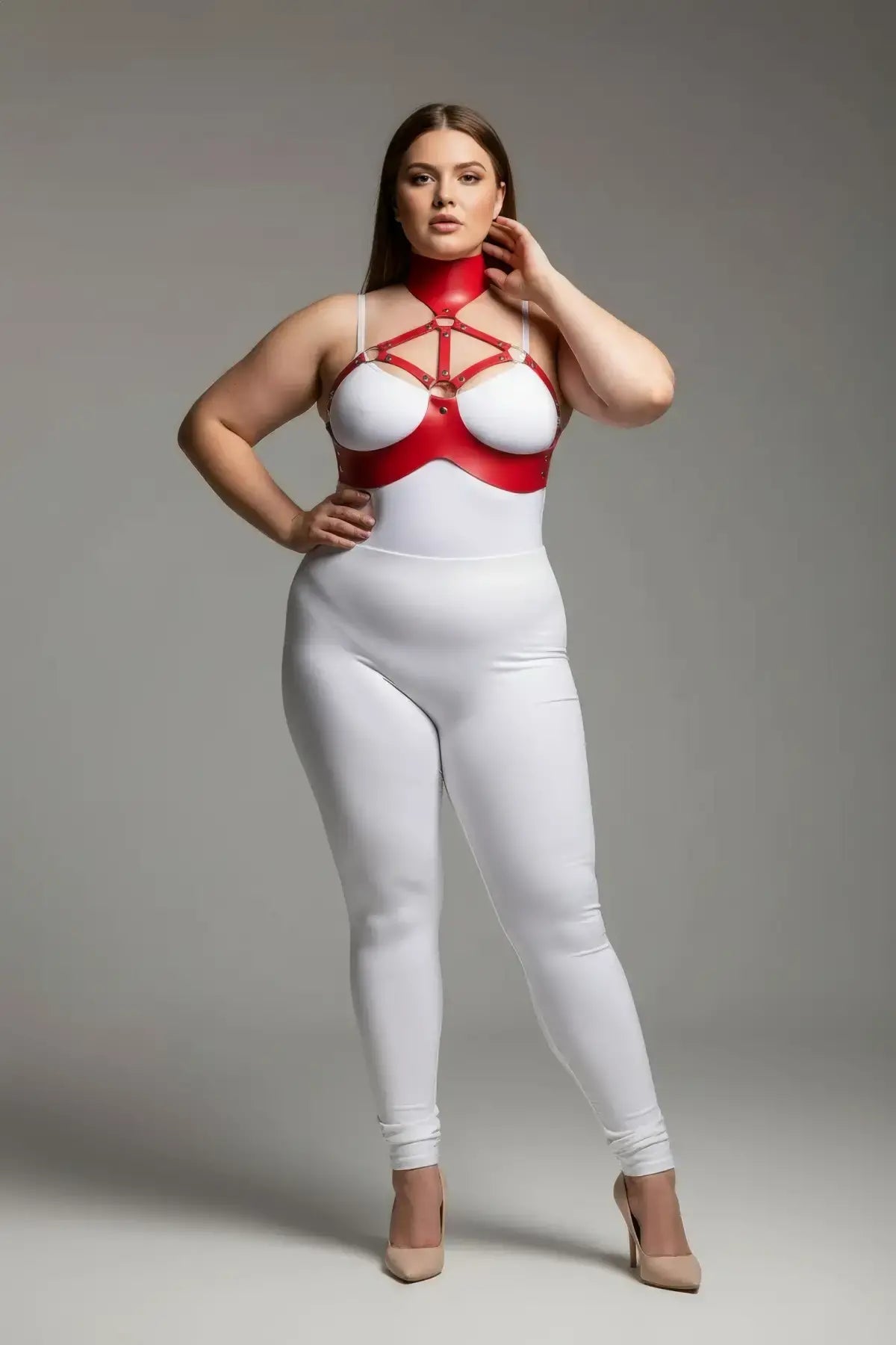 Plus-size red faux leather chest harness set with collar worn over a white bodysuit by a model