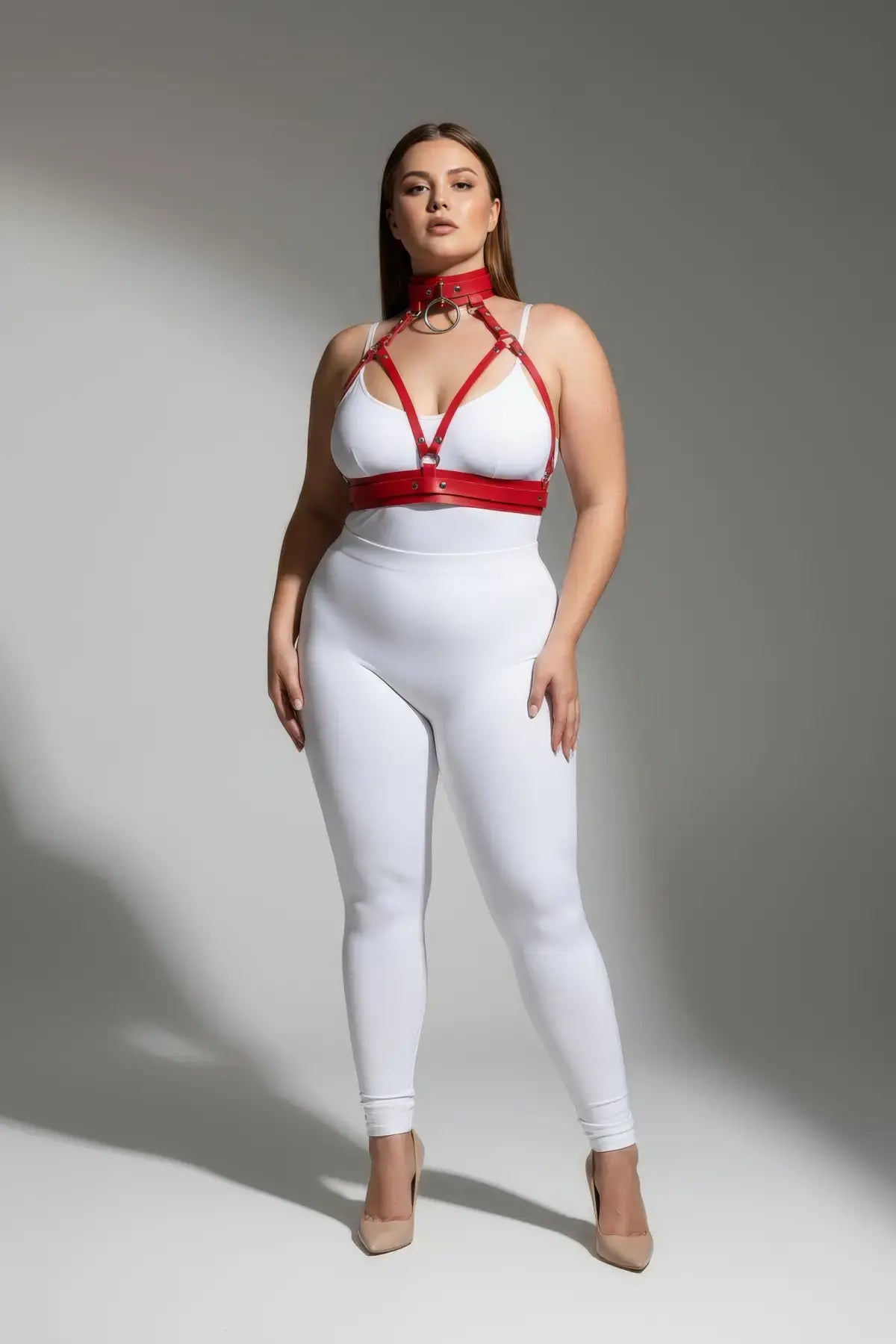 Plus-size red faux leather harness set with collar and chest straps over a white bodysuit by HarnessClub