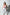Plus-size red faux-leather harness with collar and metal ring detail worn over a white bodysuit
