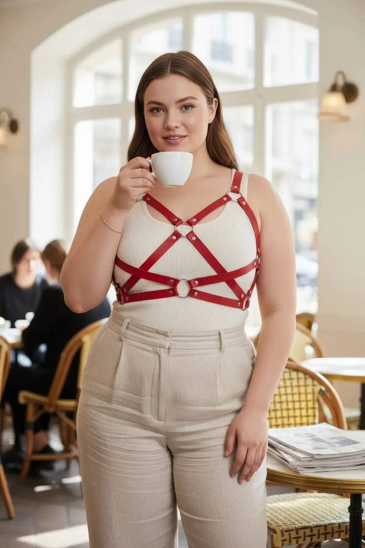 Plus-size red leather harness with corset-style straps over a white tank top.