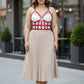 Plus-size red leather corset-style body accessory by HarnessClub worn over a white top.