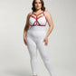 Plus-size red cross-strap faux leather harness worn by a model over a white outfit; geometric strap design.