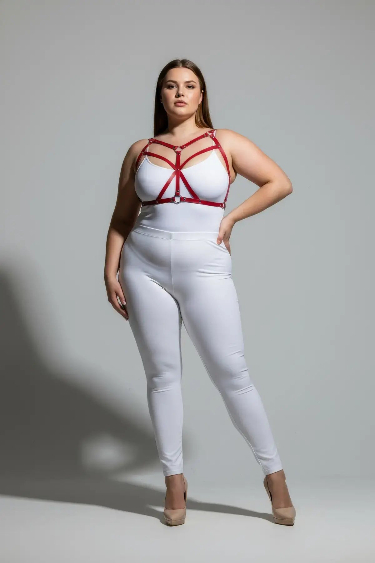 Plus-size red faux-leather cross-strap harness by HarnessClub on model