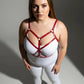 Plus Size Red Cross-Strap Faux Leather Harness worn over a white bodysuit