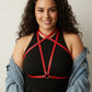 Plus-size red crossing-strap chest harness by HarnessClub, vegan leather over a black top.