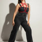 Plus-size red crossing-strap vegan leather chest harness by HarnessClub, shown over a black outfit.
