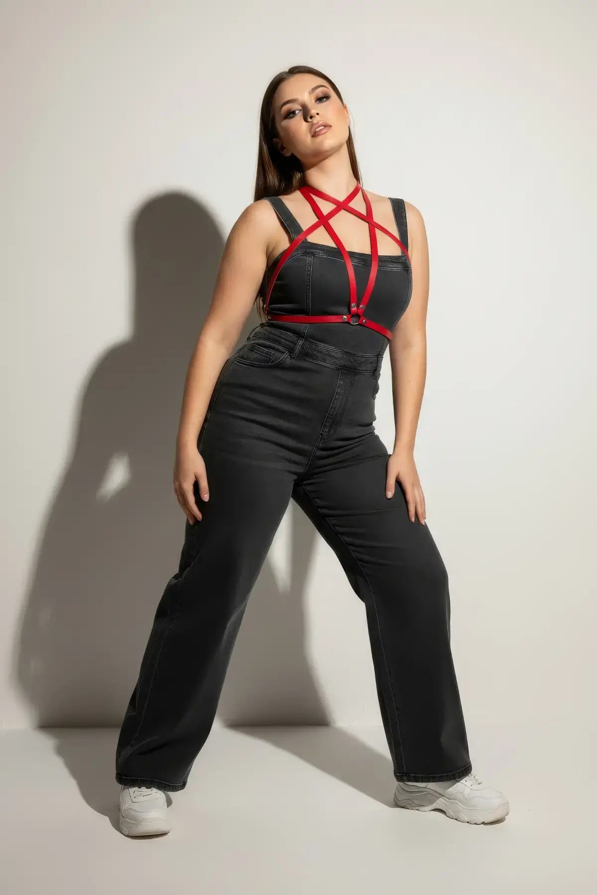 Plus-size red crossing-strap vegan leather chest harness by HarnessClub, shown over a black outfit.