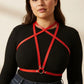 Plus-Size Red Crossing-Strap Chest Harness by HarnessClub, vegan leather with waist belt worn over a black rib-knit top
