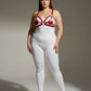 Plus-size red disc O-ring vegan leather chest harness by HarnessClub worn over white bodysuit
