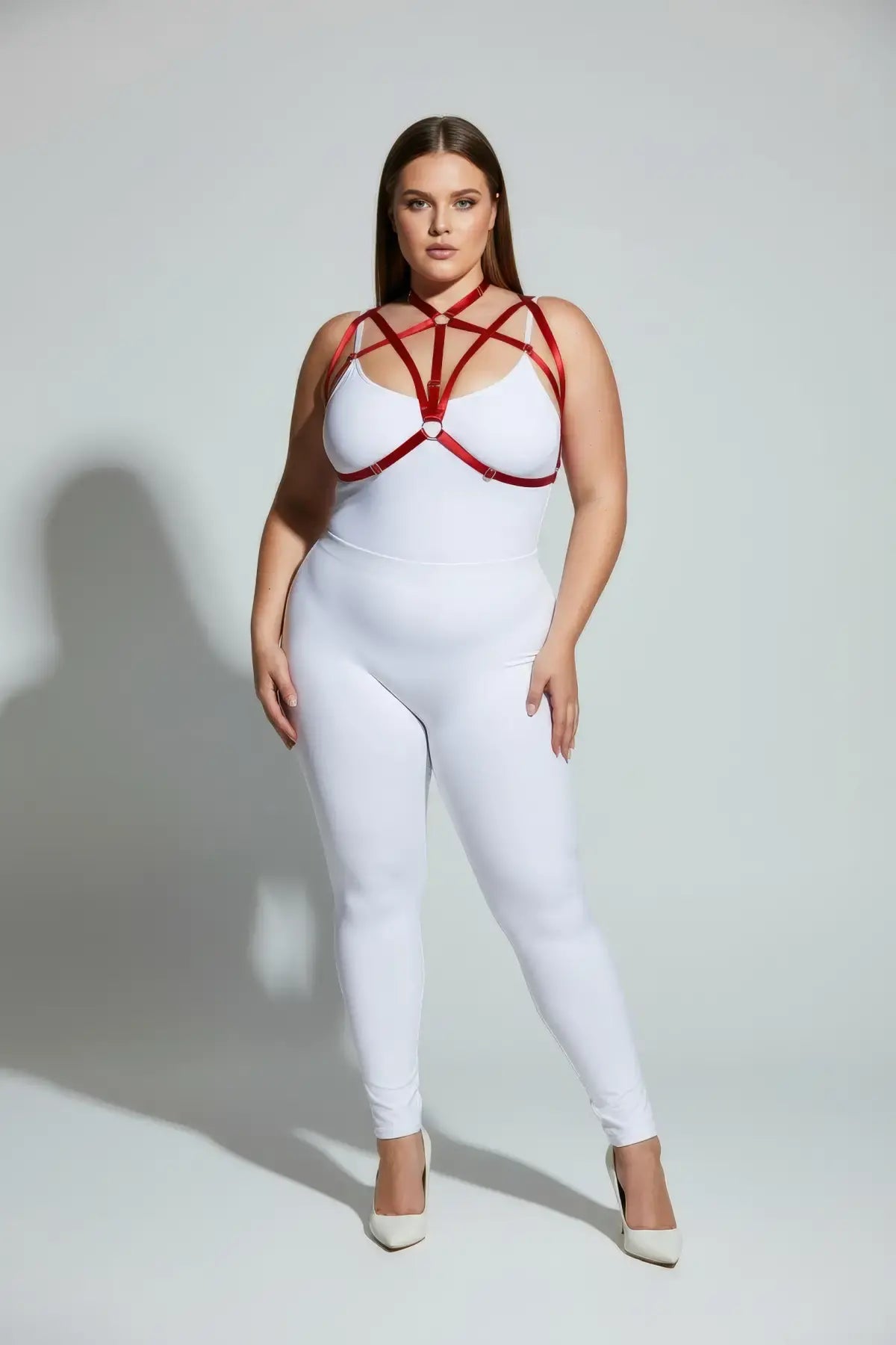 Plus-size red elastic O-ring harness set by HarnessClub worn over a white bodysuit
