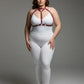 Plus-size red faux-leather body harness worn over a white bodysuit
