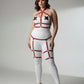 Plus-size red vegan leather garter harness body set on white bodysuit with adjustable straps.