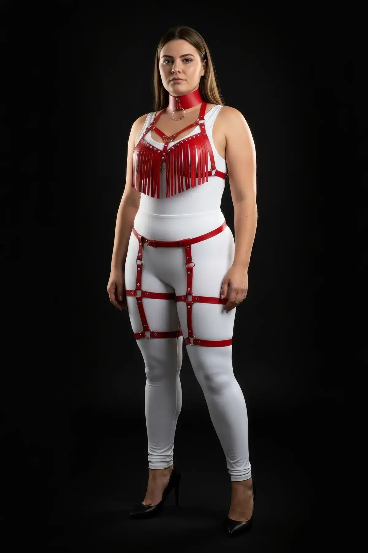 Plus-size red fringe tassel harness and garter set in vegan leather, worn over a white bodysuit.