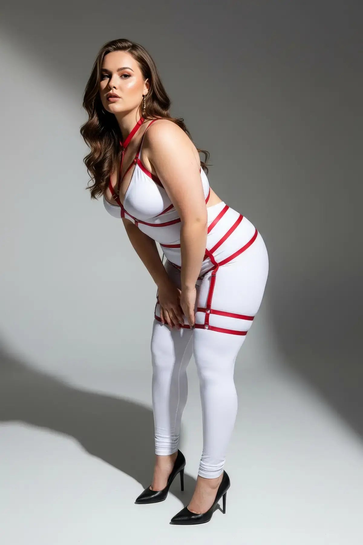 Plus-size red full-body cage garter harness with vegan leather straps on white base fabric