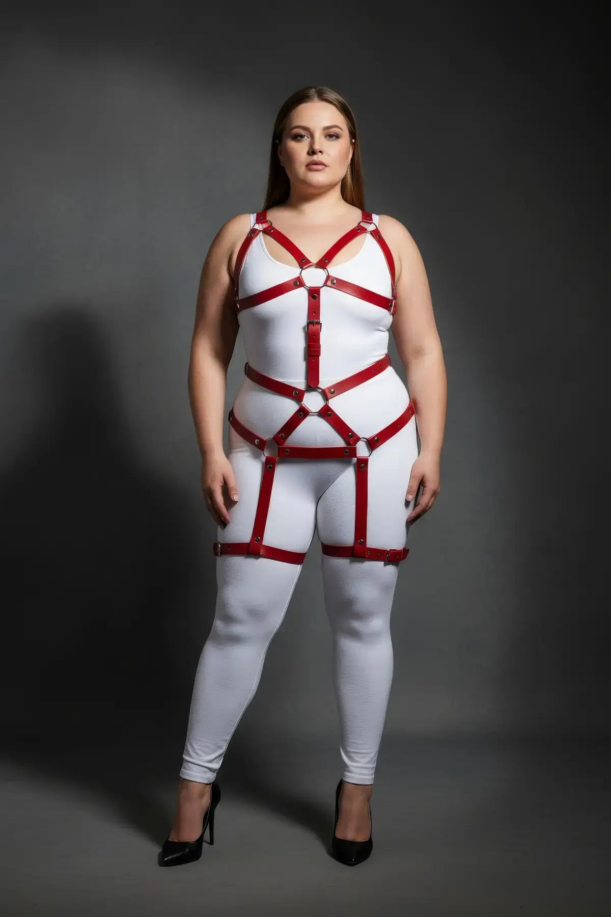 Plus-size red vegan-leather full-body garter harness worn over a white bodysuit, HarnessClub.