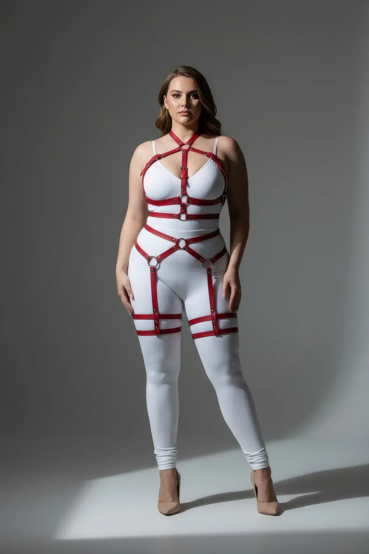 Plus-Size Red Vegan Leather Full-Body Garter Harness by HarnessClub worn by model in white bodysuit