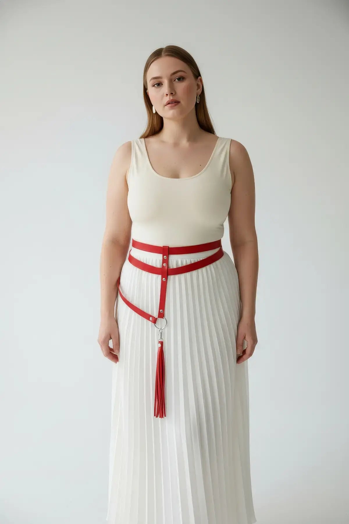 Plus size red vegan-leather garter hip belt with leg-strap tassels worn at the waist.