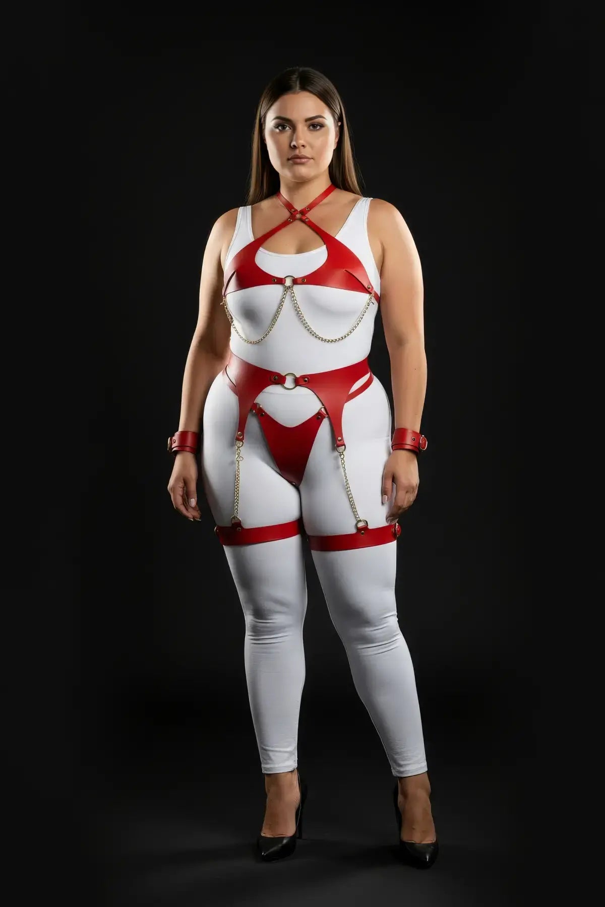 HarnessClub four-piece red vegan-leather harness set with garter belt, wrist cuffs, and gold chains.