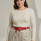 Plus-size red vegan leather belt with grommets, o-ring and chain details, worn at waist by model