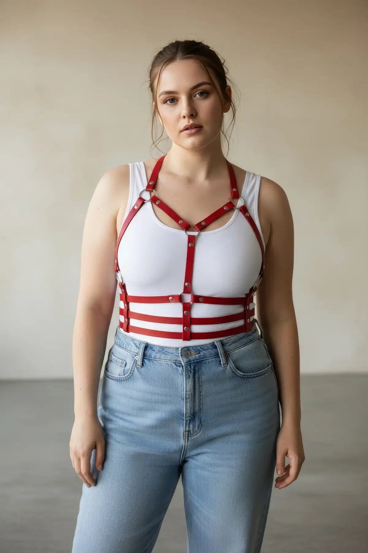 Plus-size red halter chest harness with ribcage bands in vegan leather, worn over a white tank.