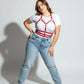 Plus-size red vegan-leather halter chest harness with ribcage bands by HarnessClub worn over a white tee