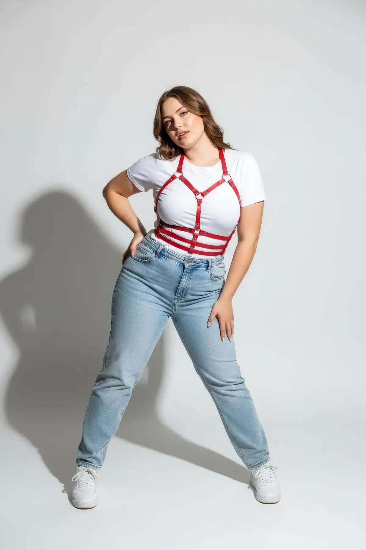 Plus-size red vegan-leather halter chest harness with ribcage bands by HarnessClub worn over a white tee