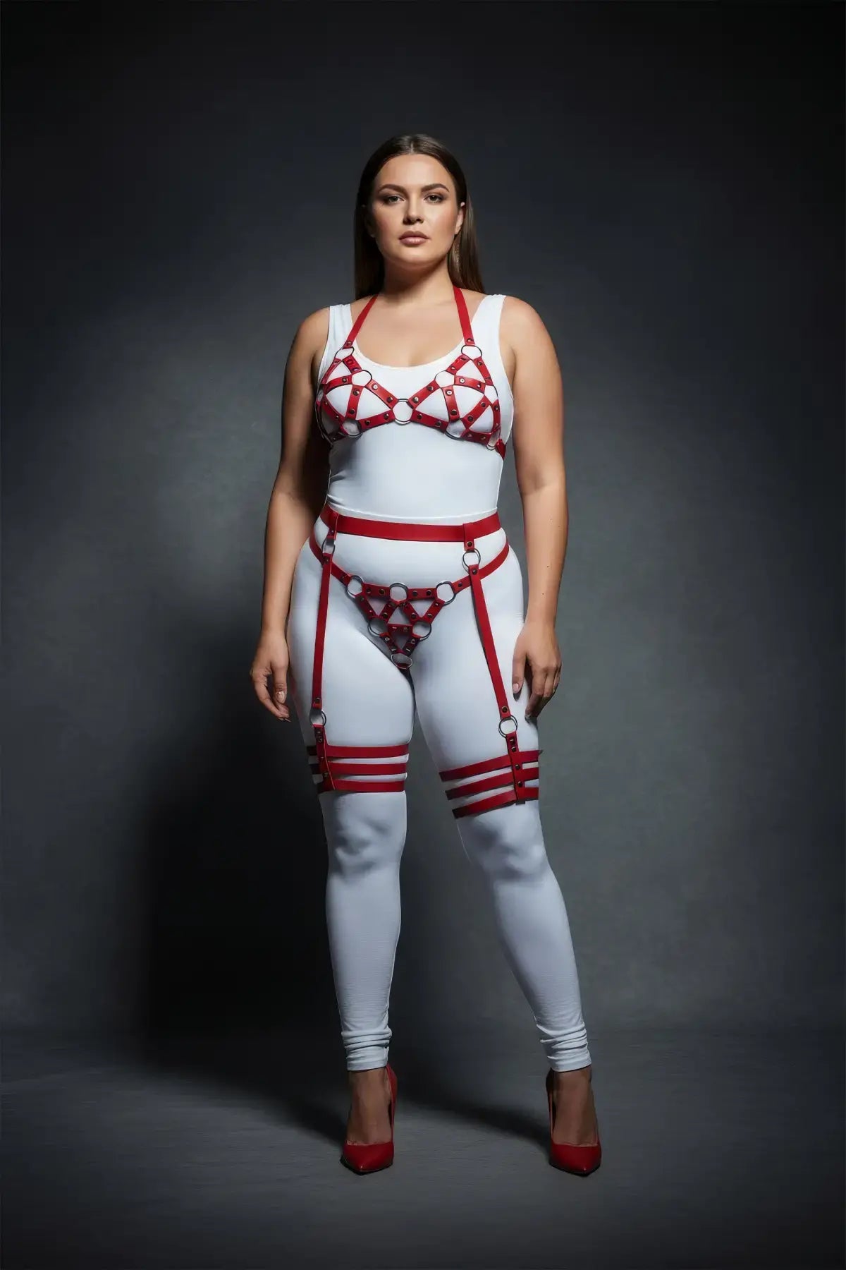 Plus-size red halterneck cage and multi-band thigh harness set by HarnessClub, vegan leather over white bodysuit.