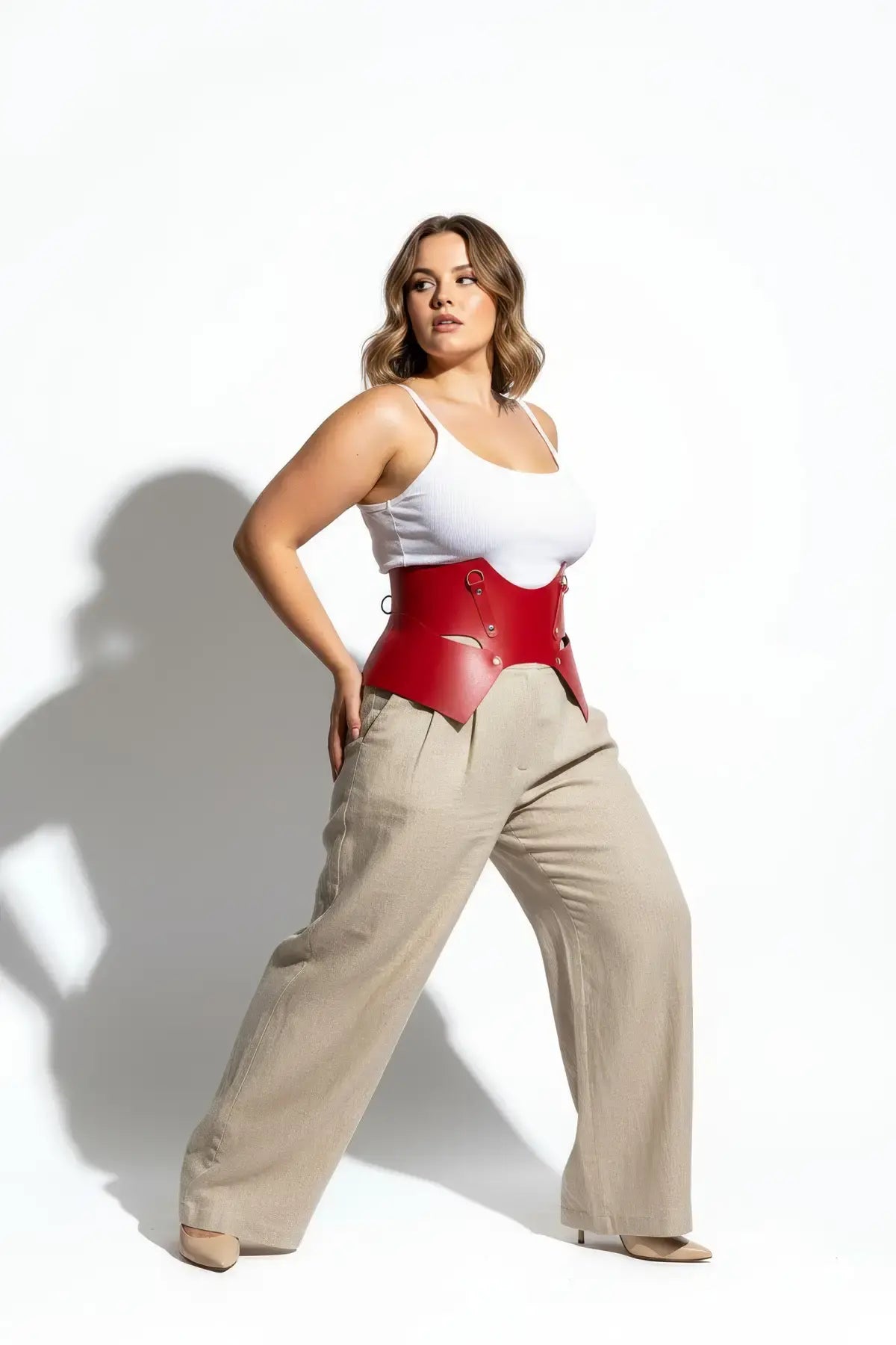 Plus size red lace-up corset belt by HarnessClub, vegan leather structured waist harness.