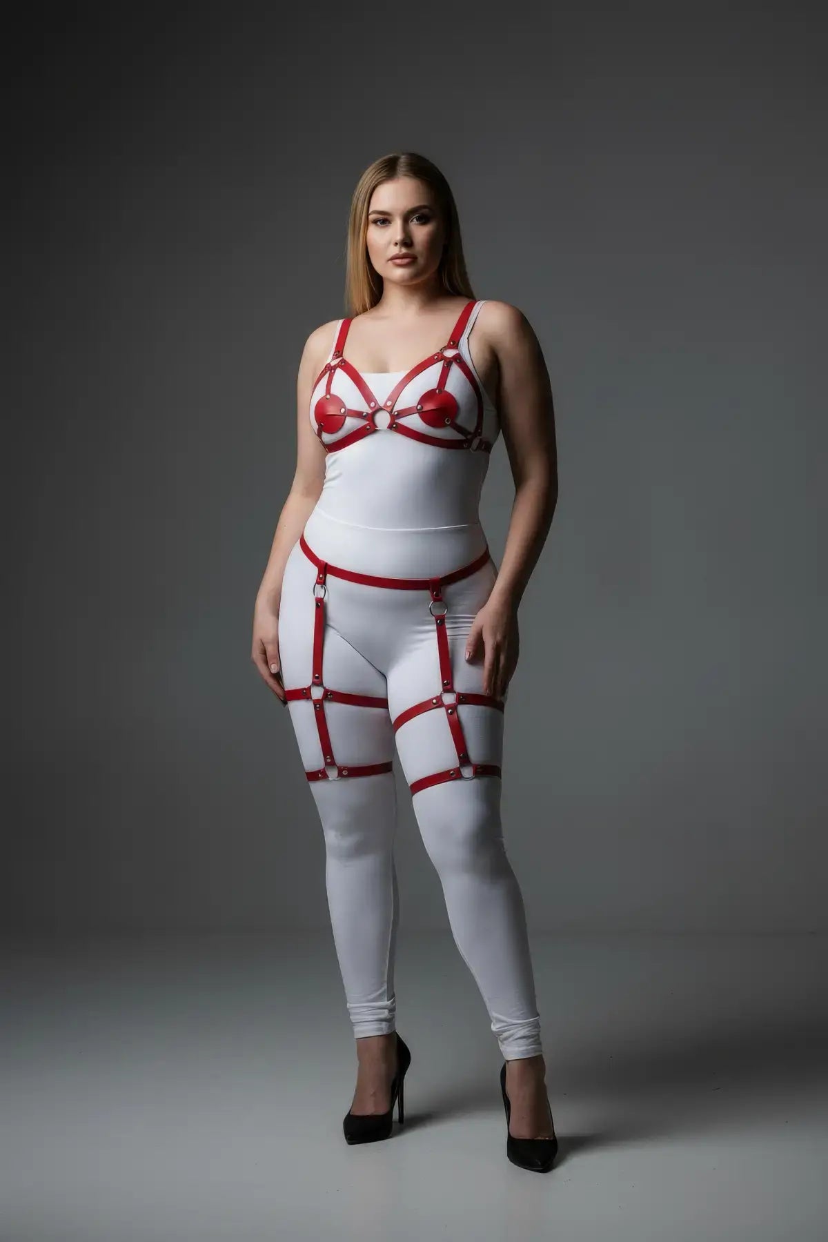 Plus-Size Red Multi-Strap Faux Leather Garter Harness by HarnessClub, worn over a white bodysuit.