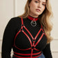 Plus-size red vegan leather O-ring collar with chest harness on a model wearing a black ribbed top.