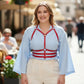 Plus Size Red Shoulder-Strap Corset Harness by HarnessClub, vegan leather body accessory worn over a light blue blouse.