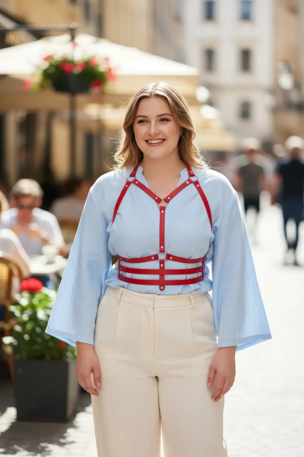 Plus Size Red Shoulder-Strap Corset Harness by HarnessClub, vegan leather body accessory worn over a light blue blouse.